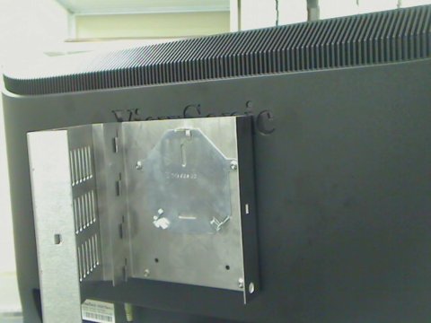 Security enclosure and standard VESA mounting bracket